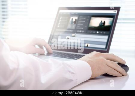 Video editing with laptop. Professional editor working in creative studio office. Stock Photo