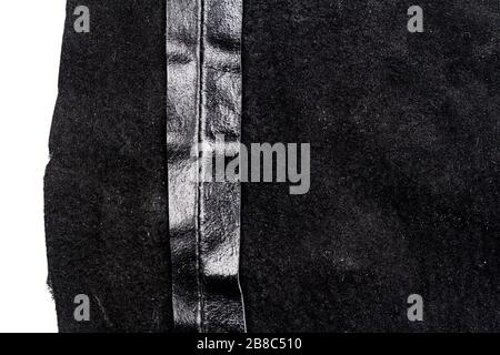 Piece of black leather isolated on white background. Crumpled material texture. Back side Stock Photo