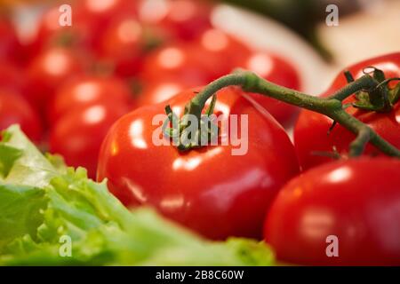 Close-up of fresh ripe tomatoes or cherry tomatoes on the table Stock Photo