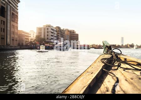 Abra boat in Dubai Creek. Water taxi in river. Passenger city view from traditional ferry. Cruising and old transportation in UAE. Travel and sailing.