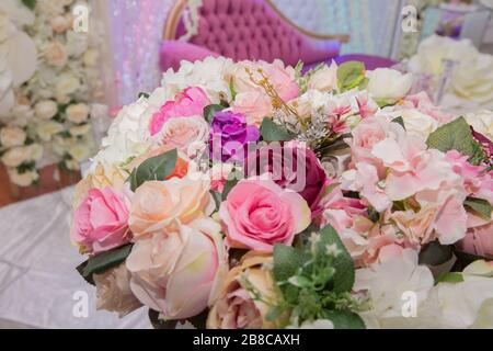 wedding table, wedding decorations . Large vase with beautiful roses stands on rich served dinner table .Wedding flower composition for guest Stock Photo