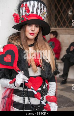 Venice Carnival characters in a colorful brown and gold Carnival costumes and masks Venice, Italy Stock Photo