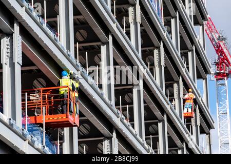 Construction workers in Glasgow continue to work through the outbreak of Coronavirus in Scotland, even as other business close down. Stock Photo