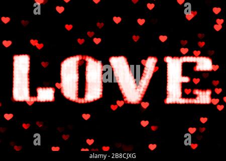 blurred text red LOVE sign LED Bokeh neon light red on background bokeh lights heart soft colorful Stock Photo