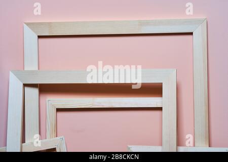 Wooden frames on a pink background. Frames for photos and paintings Stock Photo
