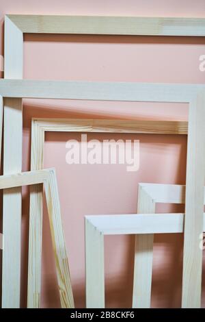 Wooden frames on a pink background. Frames for photos and paintings Stock Photo