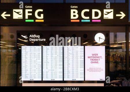 A departure flight board showing flight times and gates at Terminal 3 in Vienna Airport, Austria Stock Photo