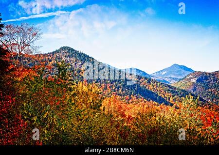 The forest covering the White Mountains shares its fall colors in New Hampshire. Stock Photo