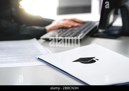 Student writing college or university application. Apply to school. Admission or grant. Teacher and computer. Principal or headmaster working. Stock Photo
