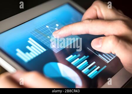 Man touching a financial analysis concept on a touch screen with his ...