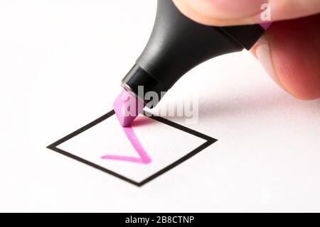 Writing checkmark in checkbox in checklist. Completed and finished task, obligation, duty or responsibility. Progress of work project. Keeping score. Stock Photo