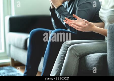 Fighting angry couple having dispute and quarrel about family or marriage issues. Wife nagging to husband. Parents in argument. Stock Photo