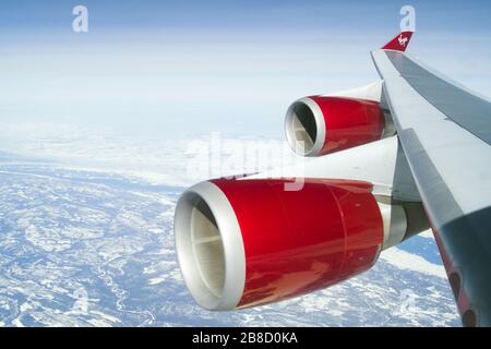 Virgin Atlantic Boeing 747-400 wing view in flight making landfall en route to New York. 747 jumbo jet quad jet four engine aeroplane airplane jet Stock Photo