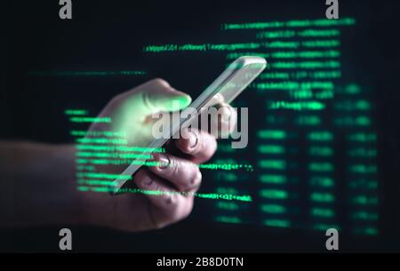 Darkweb, darknet and hacking concept. Hacker with cellphone. Man using dark web with smartphone. Mobile phone fraud, online scam and cyber security. Stock Photo