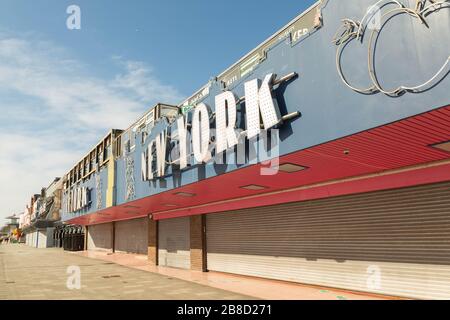 Southend-on-Sea, UK. 21st Mar, 2020. The ‘New York’ amusement arcade on Marine Parade, Southend, Essex, stands shuttered and silent during the early stages of the COVID-19 pandemic. Captured in the pre-lockdown period, the image reflects the growing public health concerns and the initial impact on leisure businesses along the seafront. Penelope Barritt/Alamy Live News Stock Photo