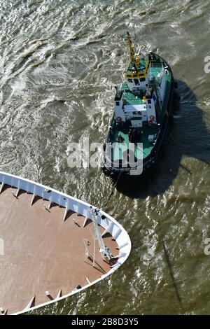 Section  and close up of almost empty front desk cruise ship from above showing almost abstract lines from bow and deck furniture and deck bell being Stock Photo