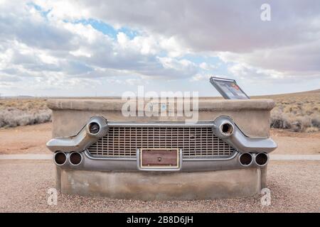 Chrome car bumper and grill encased in concrete at Route 66 Monument in the Petrified Forest National Park Stock Photo