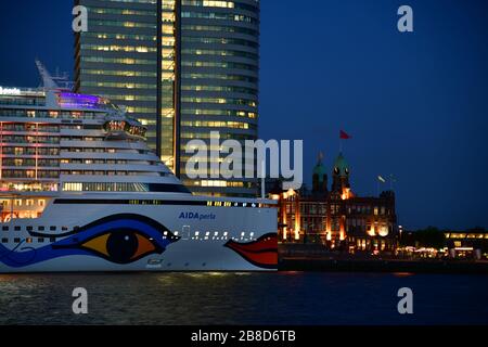 Rotterdam, The Netherlands - October 2019; Close up of bow of cruise ship moored on Wilhelminapier Rotterdam during evening brightly lit up with moder Stock Photo