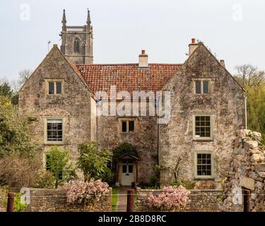 The vicarage and the church of St Mary and St Peter at Winford in Somerset UK Stock Photo
