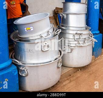 Oversized aluminium cooking pots in a shop in the town of Voi in Southern Kenya Stock Photo