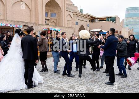 Wedding Guests Dance In The Street During A Wedding Celebration, Khiva, Uzbekistan Stock Photo