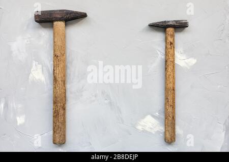 Two old rusty hammers on gray background, carpentry concept, copy space Stock Photo