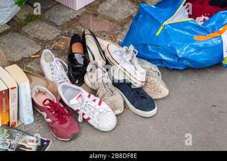 Berlin, Germany - 7 July 2019: Used shoes on a pavement to sell at Fleamarket at Mauerpark Stock Photo