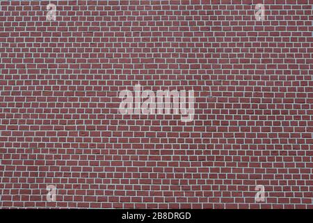 A smooth brown brick wall with white joints. Textured background. Stock Photo