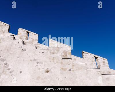 Close-up of stepped gable, a step pattern design above the roof against blue sky.
