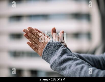 Foreground with unfocused background of hands clapping for emergency services during coronavirus quarantine Stock Photo