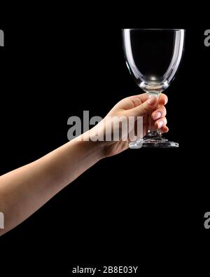 Woman hand holding empty beer glass isolated on black. Stock Photo