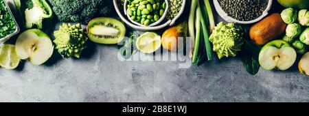 Variety of Green Vegetables and Fruits on the grey background, banner size Stock Photo