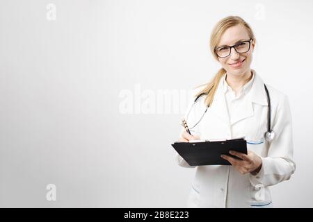 Medical expert posing in studio with clipboard Stock Photo