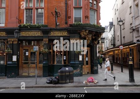 London, UK. 21st Mar, 2020. A man walks past a closed pub in Covent Garden in central London, Britain, on March 21, 2020. As of 9a.m. (0900GMT) on Saturday, 72,818 people have been tested in Britain, of which 67,800 were confirmed negative and 5,018 were confirmed positive. 233 patients in the country who tested positive for the virus have died. Credit: Tim Ireland/Xinhua/Alamy Live News Stock Photo