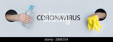 Coronavirus prevention protective yellow gloves and hand sanitizer gel for hand hygiene virus protection in female hand through paper hole. COVID-19. Stock Photo