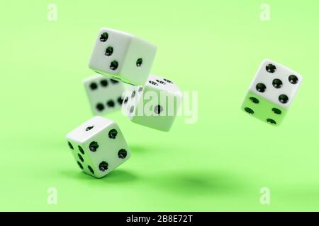 A conceptual photo of dice being rolled on a green table. Stock Photo