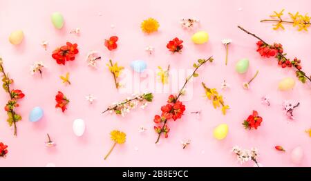 Easter eggs and spring flowers on pink background Stock Photo