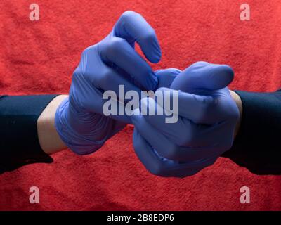 Antibacterial surgical plastic gloves on a young man hands Stock Photo