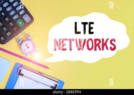 Handwriting text Lte Networks. Conceptual photo 4G wireless communications standard LongTerm Evolution Alarm clock wakeup calculator pencil clipboard Stock Photo