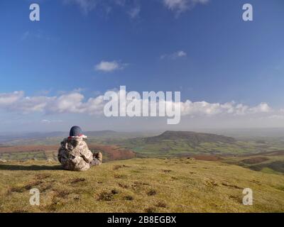 Children admire the view of The Skirrid - Ysgyryd Fawr - from the summit of The Sugarloaf - Y Fâl, near Abergavenny, Wales, UK Stock Photo