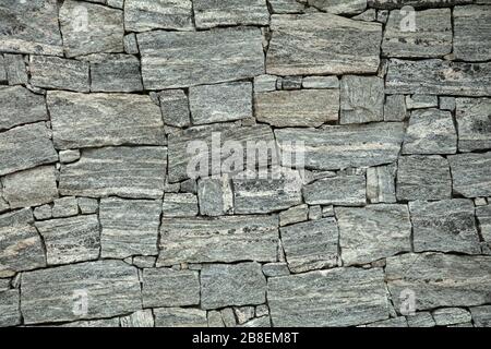 Background of random grey stone wall. Stock Photo