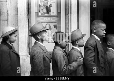 Half-Length Profiles of Children in front of Moving Picture Theater, Easter Sunday Matinee, Black Belt, Chicago, Illinois, USA, Edwin Rosskam for U.S. Farm Security Administration, April 1941 Stock Photo