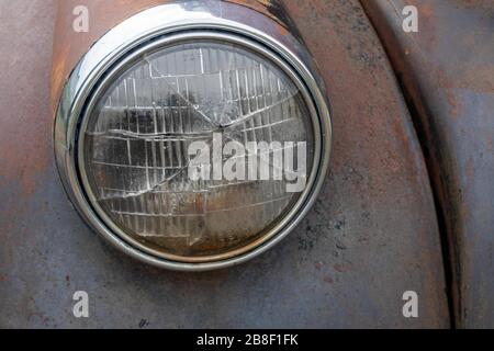 Broken headlight on an old junked automobile Stock Photo
