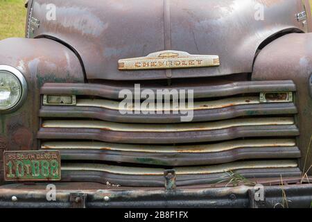 Hood of a wrecked Chevrolet in a junk yard Stock Photo
