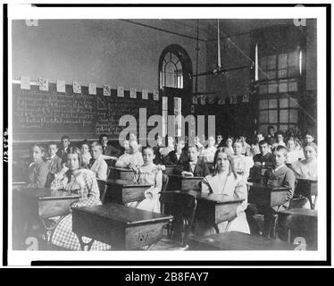 Girls and boys seated at desks in Washington, D.C. classroom Stock Photo