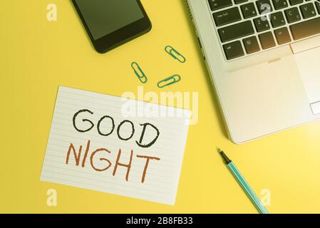 Writing note showing Good Night. Business concept for expressing good wishes on parting at night or before going to bed Trendy laptop smartphone marke Stock Photo