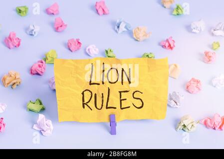 Handwriting text writing Lion Rules. Conceptual photo epitome of strength power and masculinity Master of own domain Colored crumpled papers empty rem Stock Photo