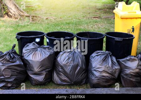 Black plastic bag with gardening waste and gloves in UK garden Stock Photo  - Alamy