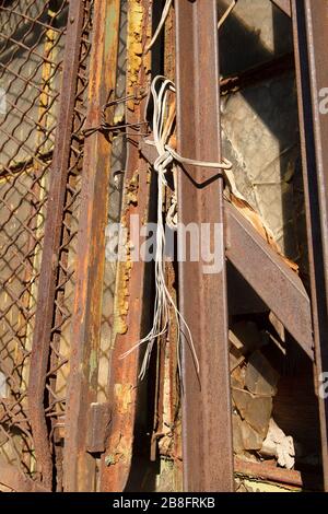 Rusted Metal Window Grate Tied to Steel Bars with Rope Stock Photo