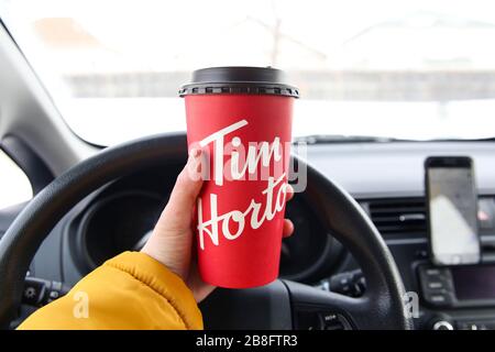 Winnipeg, Manitoba / Canada - February 17, 2020: Holding a Tim Hortons Large Cup of Coffee. Stock Photo